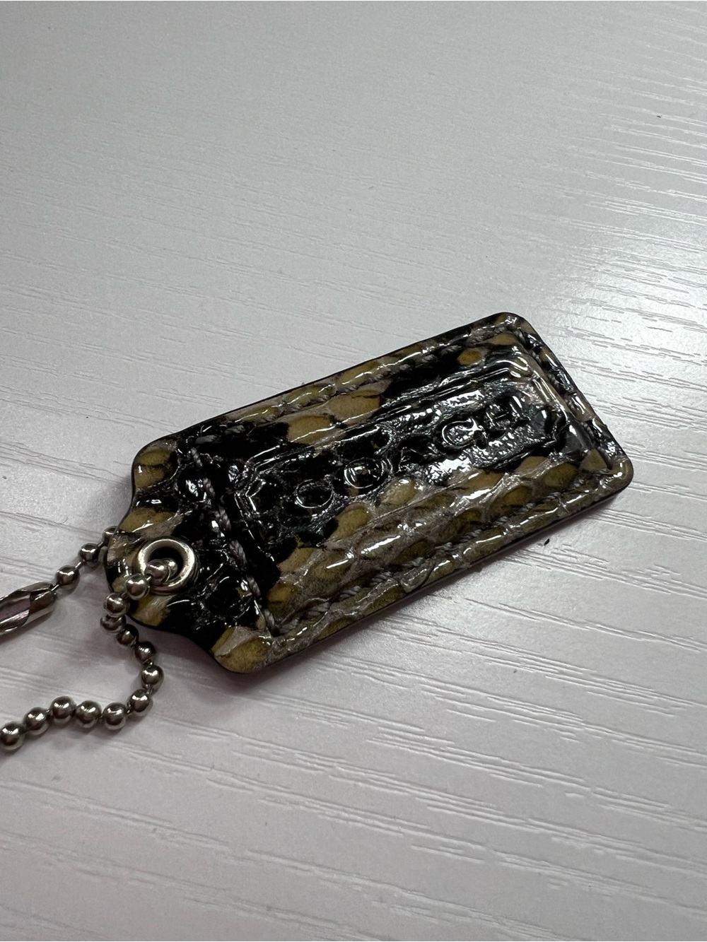 Coach Patent Leather Logo Tag in Black and Olive